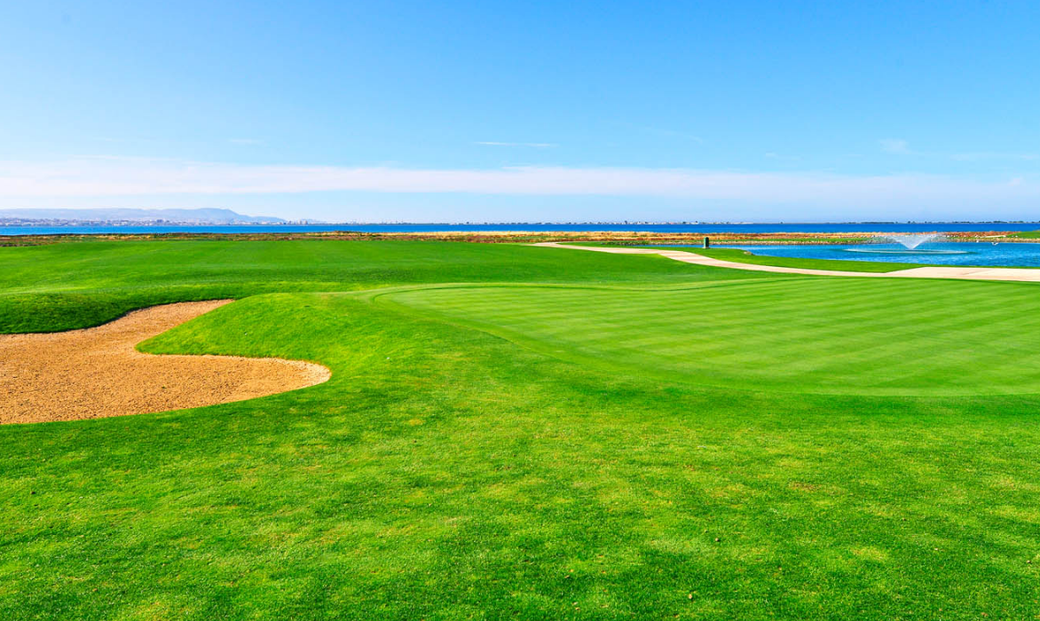 Fairway and bunker facing the Atlantic Ocean under a blue sky