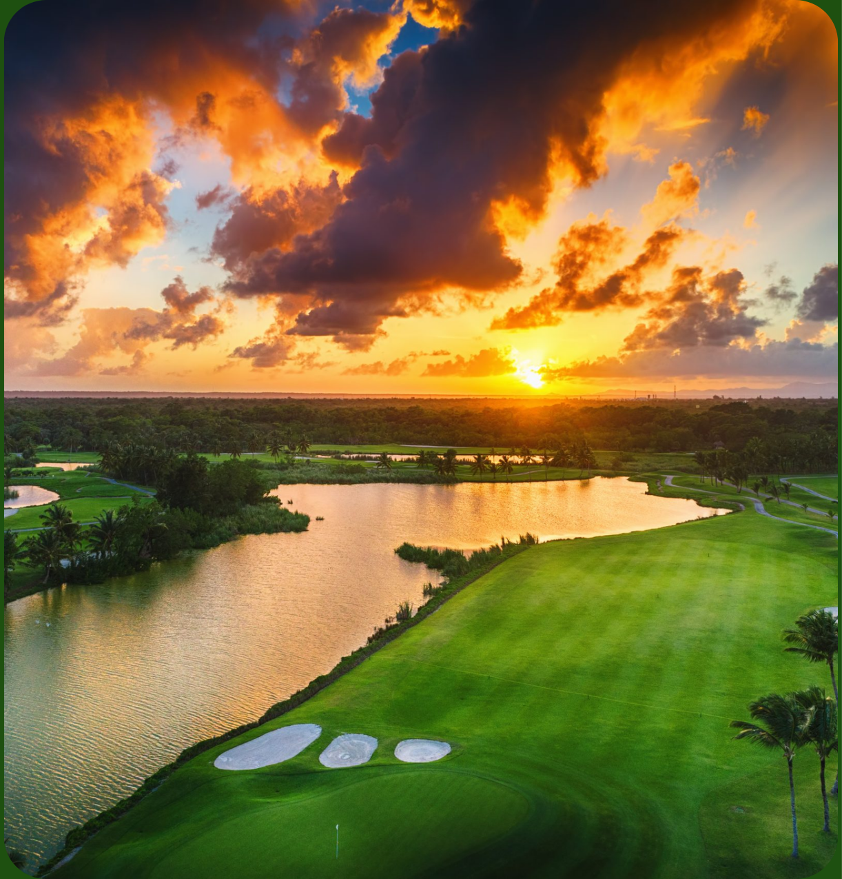 Golf course at sunset, a lake between the fairways