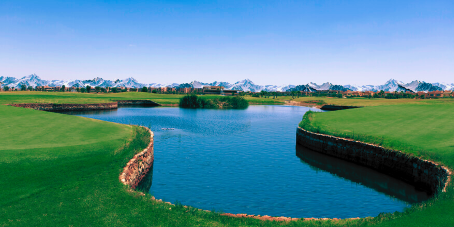 Lake and fairway on a Marrakech course, the Atlas range on the horizon